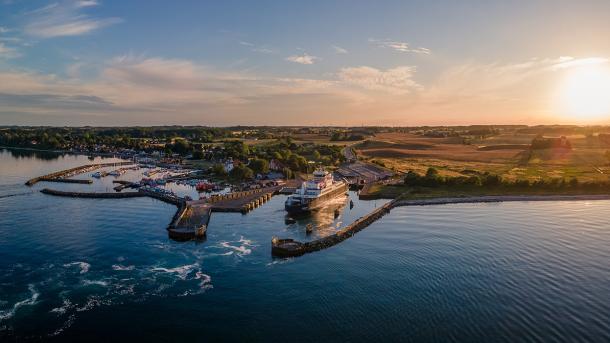 Aerial view of a ferry having just entered Spodsbjerg Harbour, Langeland on a sunny evening.